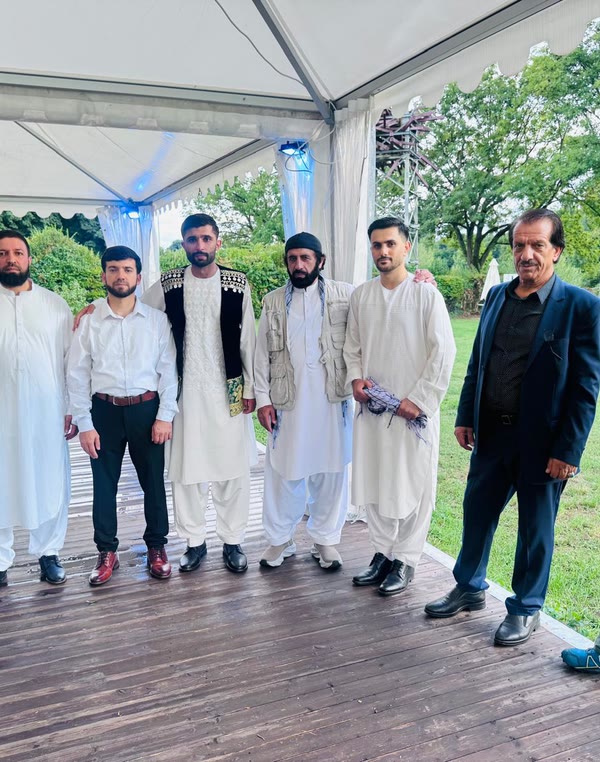 Men from the community in Afghan dress at a celebration
